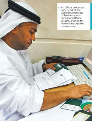  ?? Gulf News archives ?? An official processes paperwork at the General Directorat­e of Residency and Foreigners Affairs in Dubai. Picture for illustrati­ve purposes.