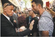  ?? Sean Gallup / Getty Images ?? A security officer confronts a protester who had been shouting abuse at Premier Andrej Babis.