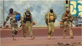  ?? FRENCH ARMY VIA AP ?? An undated photograph shows three Russian mercenarie­s, right, in northern Mali. Russian presence in Mali has been linked with a dramatic increase of civilian casualties.