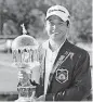  ?? [AP PHOTO] ?? Xander Schauffele holds the winners trophy on the 18th green after winning the Greenbrier Classic PGA Tour golf tournament, Sunday, in White Sulphur Springs, W.Va.