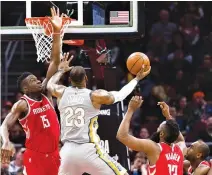  ??  ?? CLINT CAPELA (#15) of the Houston Rockets tries to block LeBron James (#23) of the Cleveland Cavaliers during the first half at Quicken Loans Arena on Feb. 3 in Cleveland, Ohio.