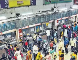  ?? PTI ?? Passengers buy train tickets at Sealdah station in Kolkata after local trains resumed services on Wednesday.