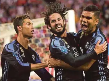  ?? PIC
EPA ?? Real Madrid’s Isco (centre) celebrates with teammates with Casemiro
(right) and Ronaldo during their Champions League semifinal match against Atletico Madrid on Wednesday.