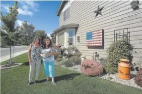  ?? Jenny Sparks, Loveland Reporter-Herald ?? Colleen Stephens, right, and daughter Christine Wylie stand in Stephens’ Loveland yard Thursday.