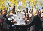  ?? SCOTT OLSON GETTY IMAGES ?? Mourners release doves during a ceremony for Daunte Wright on Thursday at Lakewood Cemetery.