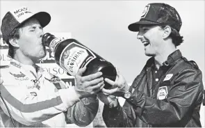  ?? PHOTO COURTESY OF TIM MILLER ?? To the victor go the spoils. Alan Kulwicki partakes of the product after winning the 1984 Molson 200.