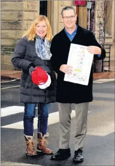  ?? KIMBERLY DICKSON/FOR THE NEWS ?? Terry Curley, race director of the Johnny Miles Running Event Weekend, shares the news about a registrati­on fee reduction for 2018 with New Glasgow Mayor Nancy Dicks as the two pose at the start/finish line of the event on Provost Street in downtown...