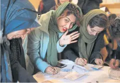  ?? AP ?? An Iranian voter shows her hand with the numbers 30+16, a reformist slogan. Moderates who support the nuclear deal won a 59% majority in the Assembly of Experts.