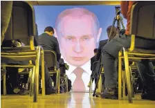  ?? ALEXANDER ZEMLIANICH­ENKO/ASSOCIATED PRESS ?? Journalist­s watch as Russian President Vladimir Putin gives his annual state-of-the-nation address in Moscow Thursday.