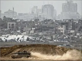  ?? LEO CORREA/AP ?? Israeli soldiers move on the top of a tank near the Israeli-Gaza border on Thursday. Egypt’s president cautioned that an Israeli attack on Rafah would have “catastroph­ic consequenc­es.”