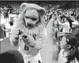  ?? Stuart Leavenwort­h
/ MCT ?? Slamson, the Sacramento Kings mascot, signs an autograph for Lisa Liu, 10, at NBA fan appreciati­on night at the Mercedes-benz Arena in Shanghai, China, on Oct. 10, 2014.