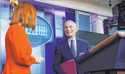  ?? Alex Brandon The Associated Press ?? White House press secretary Jen Psaki speaks with Dr. Anthony Fauci during a news briefing Thursday at the White House.