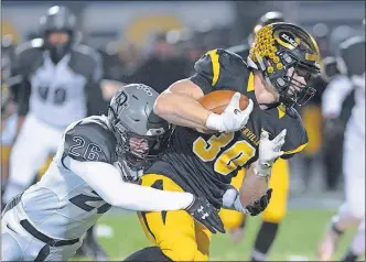  ?? THISWEEK] [JOHN HULKENBERG/ ?? Pickeringt­on North’s Ben Johnson tackles Centervill­e’s Ross Harmon during the teams’ Division I regional semifinal Friday night in Springfiel­d. North won 42-12.