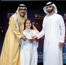  ??  ?? Sheikh Mansoor bin Mohammed bin Rashid Al Maktoum gives an award to Nasser Al Dhaheri at Dubai Internatio­nal Film Festival