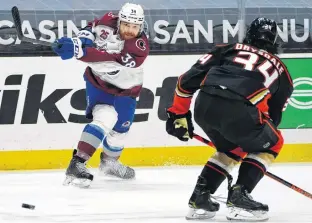  ?? GARY A. VASQUEZ • USA TODAY SPORTS ?? Colorado Avalanche winger Liam O'brien shoots past Anaheim Ducks defenceman Jamie Drysdale during an April 4 NHL game in Anaheim.