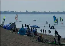  ?? AP Photo/Jeff Chiu ?? People visit Robert W. Crown Memorial State Beach during the coronaviru­s outbreak in Alameda, Calif., on Saturday.