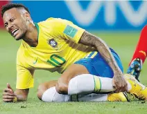  ?? FRANCISCO SECO/AP ?? Brazil’s Neymar holds his shin during the quarter-final Friday between Brazil and Belgium that saw Brazil’s hopes for a sixth World Cup title dashed by a 2-1 Belgium victory in Kazan, Russia.