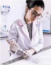  ?? PEDRO VILELA/GETTY ?? Anna Raquel Ribeiro dos Santos, works on the standardiz­ation of a rapid test for the diagnosis of coronaviru­s Tuesday in Belo Horizonte, Brazil.