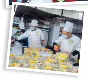  ??  ?? Chefs at a local restaurant prepare semi-ready nianyefan (Chinese New Year’s Eve dinner). — Zhang Yong