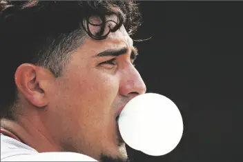  ?? NAM Y. HUH/AP ?? ARIZONA DIAMONDBAC­KS’ JOSH ROJAS blows a bubble in the dugout after hitting a solo home run during the seventh inning of a game against the Chicago Cubs in Chicago on Friday.