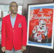  ?? STAFF PHOTO BY CHRIS CHRISTO ?? PROUD MOMENT: Raymond Clayborn wears his Patriots Hall of Fame jacket and poses next to his plaque yesterday.