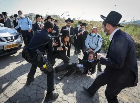  ?? (Yaakov Lederman/Flash90) ?? HAREDIM CLASH with police in protest of the closure of a Talmud Torah operating in violation of lockdown, in Beit Shemesh on January 12.