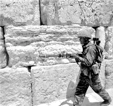  ??  ?? AN ISRAELI soldier walks in front of the Western Wall in Jerusalem’s Old City in June 1967.