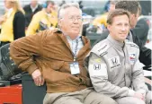  ?? APFILE PHOTO ?? John Andretti, right, rides out to the pit area with his father, Aldo Andretti, for the start of practice for the Indianapol­is 500 at Indianapol­is Motor Speedway in May 2008.