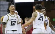  ?? L.G. PATTERSON — THE ASSOCIATED PRESS ?? Missouri’s Dajuan Gordon, left, celebrates their 92-86 victory after defeating Alabama in Saturday’s game in Columbia, Mo.