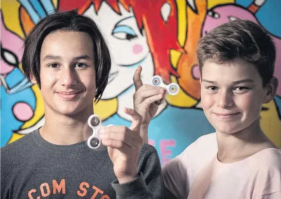  ?? Picture / Michael Craig ?? Belmont Intermedia­te students Zephyr Lovelock, 11, and Toby Cotter, 12, are doing a nice trade importing fidget spinners to sell to mates at school.