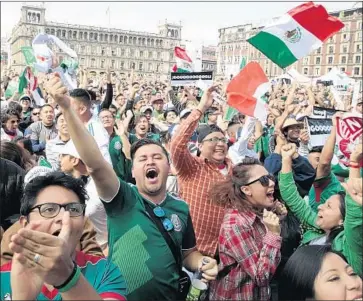  ?? Mario Guzman EPA/Shuttersto­ck ?? FANS OF MEXICO’S soccer team celebrate in the nation’s capital when El Tri reaches the round of 16.