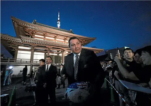  ?? AP ?? All Blacks coach Steve Hansen signs an autograph after attending the team’s welcome ceremony last weekend.