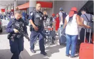  ?? MIKE STOCKER/SOUTH FLORIDA SUN-SENTINEL ?? A heavy police presence was seen at the Ft. Lauderdale­Hollywood Internatio­nal Airport after it re-opened on Saturday, the day after a shooting that killed five people.