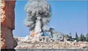  ?? AP ?? Smoke arises from the detonation of the 2,000-year-old temple of Baalshamin in Syria’s ancient city of Palmyra; (left) explosives at the site.