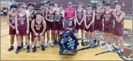  ?? Photo courtesy of Siloam Springs School District Athletics ?? Members of the Siloam Springs ninth grade boys basketball team pose with Carmen and Porky, parents of former Siloam Springs standout India Lewis, after the Panthers won the India bracket of the India Lewis Panther Classic on Saturday, Nov. 19, inside Panther Activity Center.