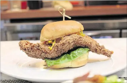  ?? PHOTOS CONTRIBUTE­D BY TODD RICHARDS ?? Richards’ Southern Fried’s catfish sandwich is minimally dressed with lettuce and chow chow.