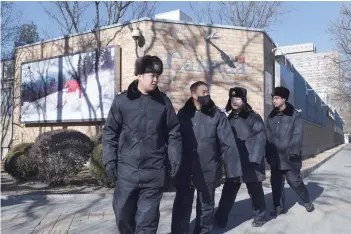  ?? — AFP ?? Chinese police patrol in front of the Canadian Embassy in Beijing on Thursday.