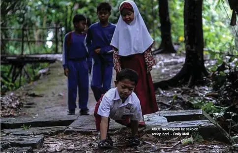  ??  ?? ADUL merangkak ke sekolah setiap hari. - Daily Mail