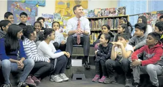  ?? CHRIS YOUNG/THE CANADIAN PRESS ?? Federal Finance Minister Bill Morneau spoke with students from Toronto’s Rose Avenue Junior Public School before a pre-budget photo opportunit­y in Toronto on Friday.