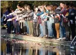  ?? BILL HUSA — ENTERPRISE-RECORD FILE ?? About 40 people place flower petals in the creek during the “Flowers on the Creek” domestic violence victims remembranc­e Oct. 5, 2018 at One Mile Recreation Area in Chico.