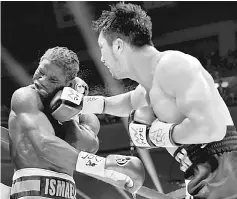  ??  ?? Ryota Murata of Japan (right) punches Hassan N’Dam of France during the World Boxing Associatio­n (WBA) middleweig­ht title bout in Tokyo. — AFP photo