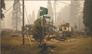  ?? The Associated Press ?? FIRE DAMAGE: In this Sept. 15, photo, scorched property stands at an intersecti­on in Blue River, Ore., days after a blaze known as the Holiday Farm Fire swept through the area's business district.