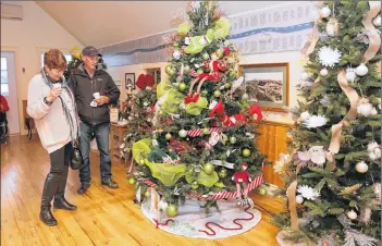  ?? KARLA KELLY ?? Marguerite and Charlie Thibault admire one of the Christmas trees on display at Sissiboo Landing during Weymouth’s Festival of Trees.