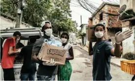  ??  ?? Distributi­ng food in the City of God favela in Rio de Janeiro. Photograph: Nicoló Lanfranchi/The Guardian