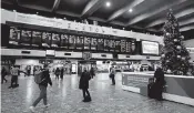  ?? MATT DUNHAM AP ?? People wait to board trains at Euston railway station in London on Friday.