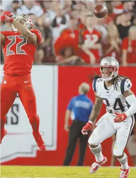  ?? STAFF PHOTO BY MATT STONE ?? LUCKY BREAK: Cornerback Stephon Gilmore watches as a pass slips through the hands of Bucs running back Doug Martin during the Pats’ win last night in Tampa.