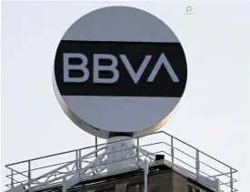  ?? /Reuters ?? Seeking savings: The logo of BBVA is displayed in Barcelona on May 2. Spain’s second-largest bank has made a bid for the fourth-largest bank, Sabadell, in an attempt to diversify away from developing economies such as Mexico and Turkey.