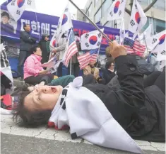  ??  ?? A supporter of Park Geun-hye reacts after a court sentenced the former president to 24 years in prison, during a rally outside the Seoul Central District Court in Seoul on Friday. — AFP