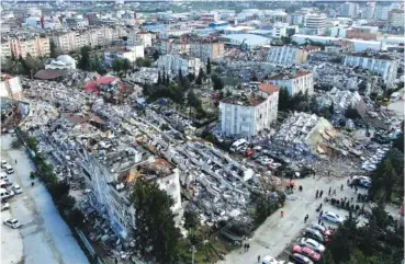  ?? IHA VIA AP ?? Blocks of flats are reduced to rubble Tuesday in Hatay city center, southern Turkey.