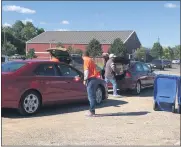  ??  ?? Painesvill­e Township Trustees Chuck Hillier and Josh Pennock and administra­tor Mike Manary unload documents from Painesvill­e Township residents. JUSTIN RANSOM - THE NEWS-HERALD